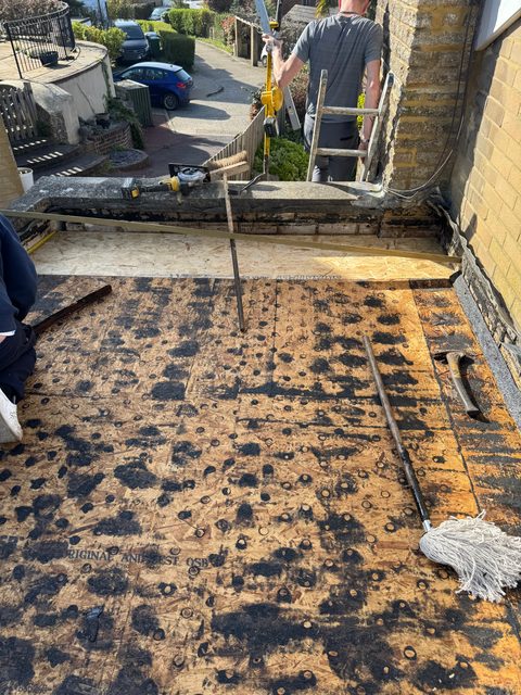 Storm Dry Roofing flat roof job: old felt off and the deck swept clear, ready for the new layers