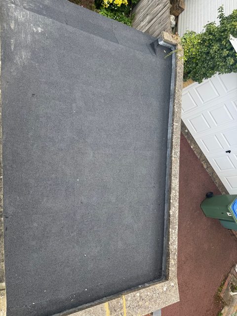 Storm Dry Roofing: finished garage flat roof in new grey mineral felt, dressed up to the coping