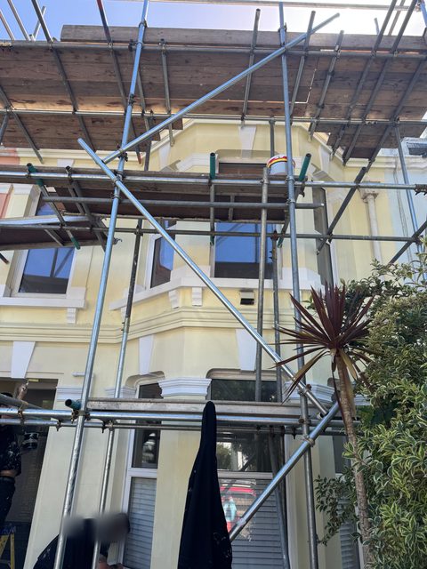 Storm Dry Roofing scaffold up the front of a period house with bay windows, giving safe access to the roof